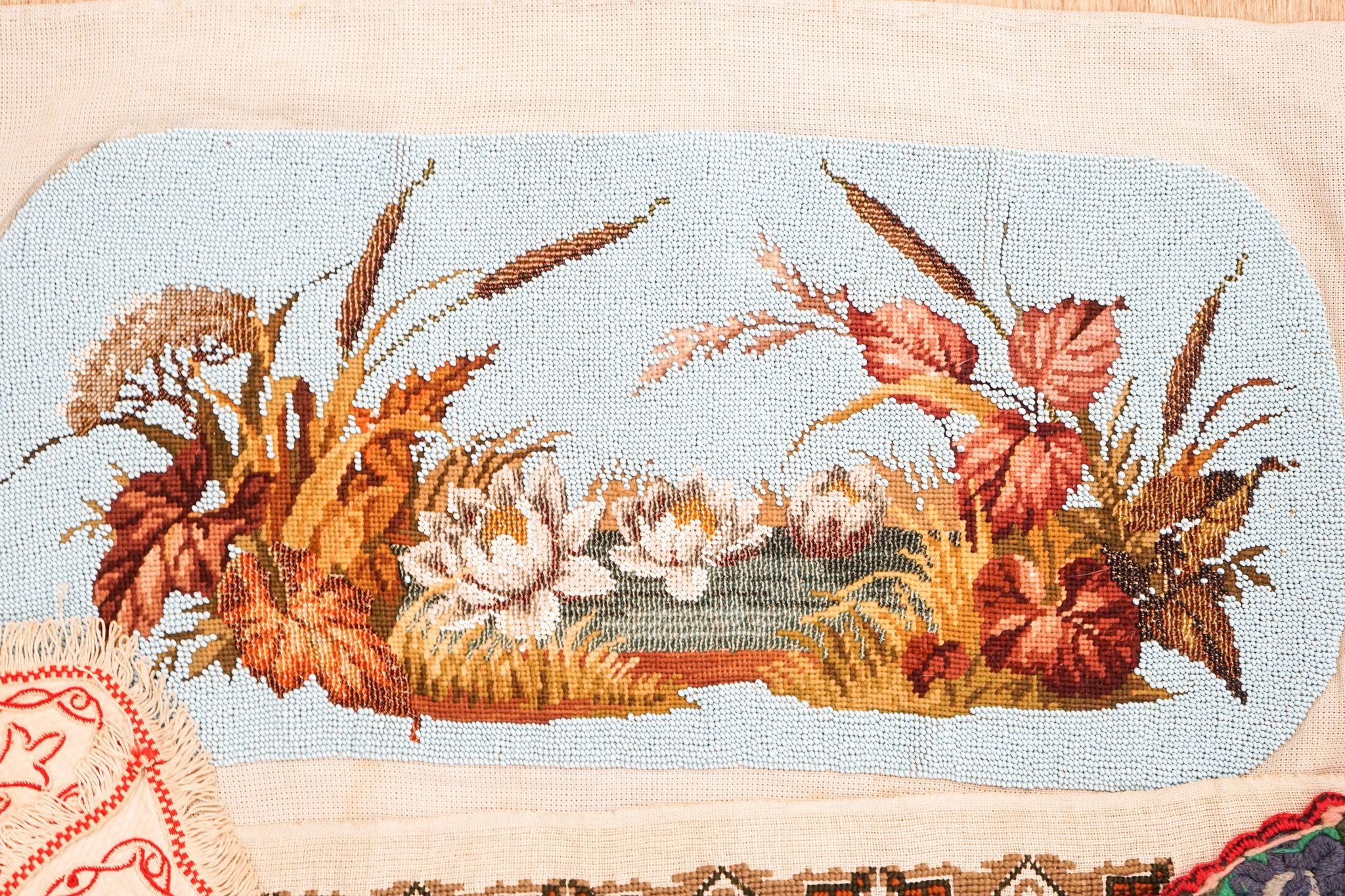 A Berlin beadwork tray panel, an Indian embroidered cloth etc.